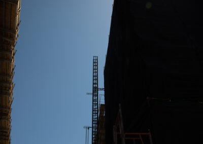 silhouette of a builder with a crane overhead