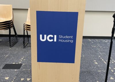 UCI Student Housing branded podium.